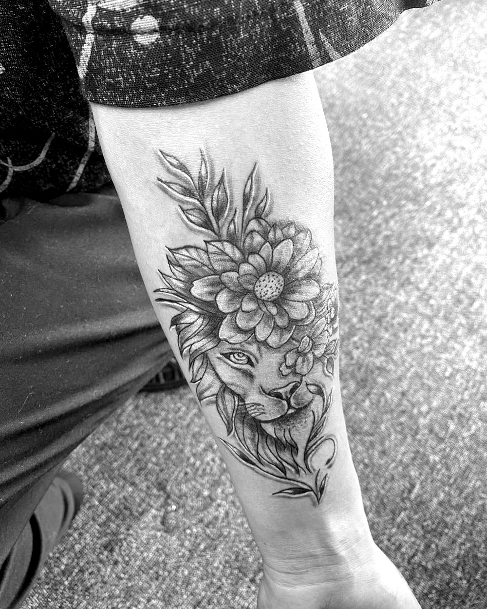 Lion and floral forearm tattoo by AZ Tattooz